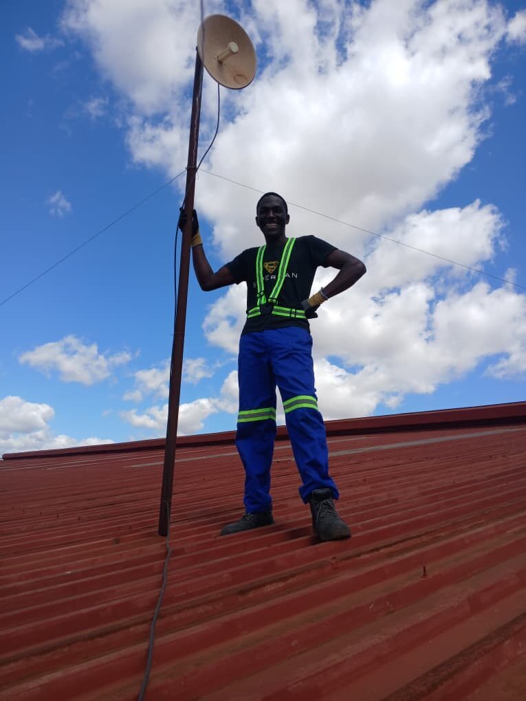 Martin Mzumara with rooftop antenna install